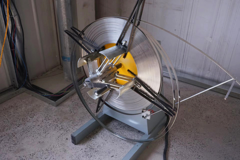 Steel-belt coil mounted on a decoiler in the Green State workshop